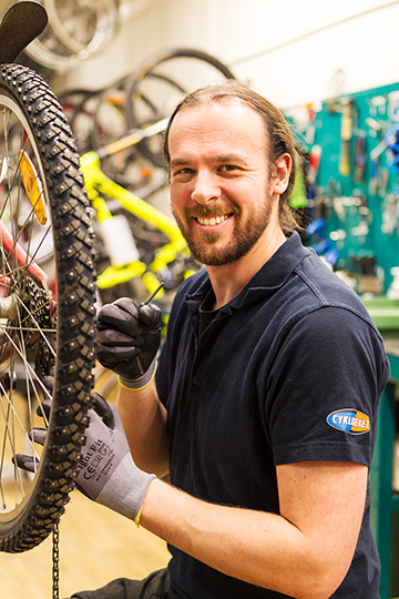 Store employee at an Evercate customer servicing a bicycle